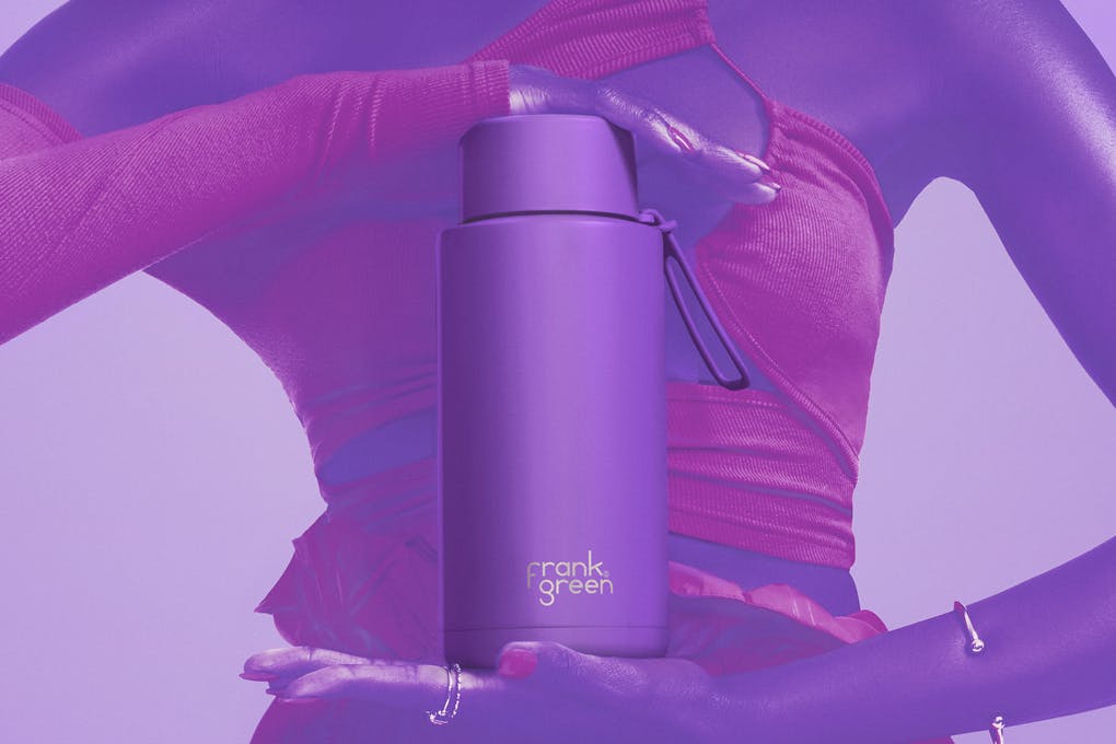A person holding a purple drink bottle.